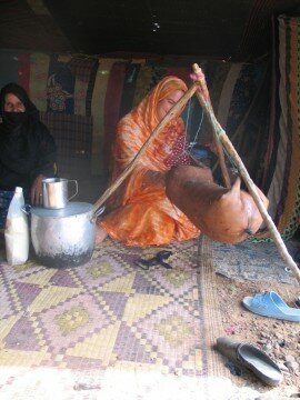 The old matriarch laughs as I try to rock the goatskin holding jeera